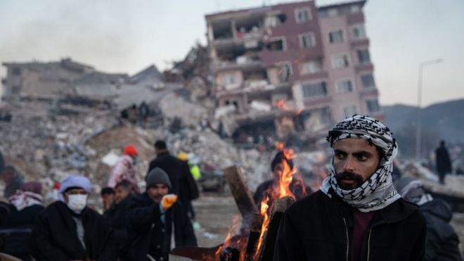 People wait for news of their loved ones, believed to be trapped under collapsed buildings on February 09, 2023 in Hatay, Turkey