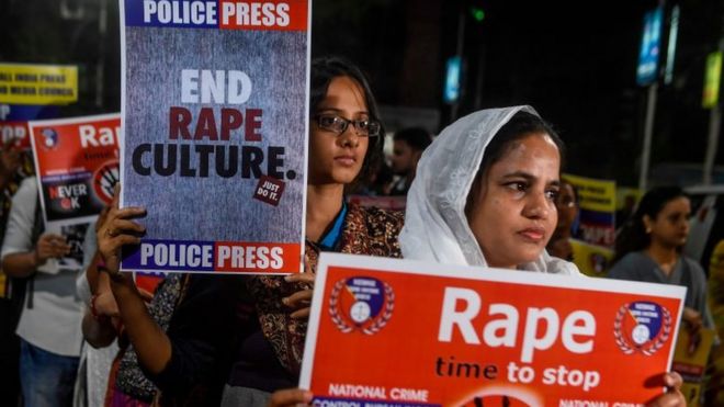 Demonstrators in India hold placards to protest against sexual assaults on women. File photo