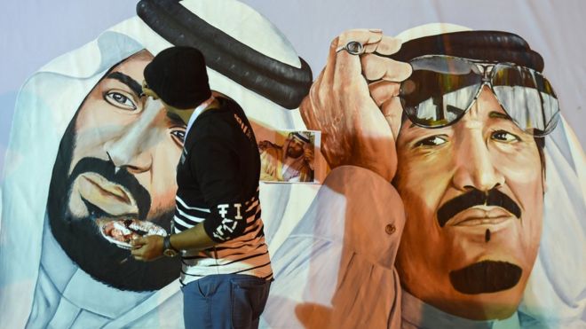 Saudi artists paint a mural portrait of King Salman bin Abdulaziz (R), and his son Crown Prince Mohammed bin Salman, during the 32nd Janadriyah Culture and Heritage Festival, held on the outsts of the capital Riyadh on 17 February 2018.