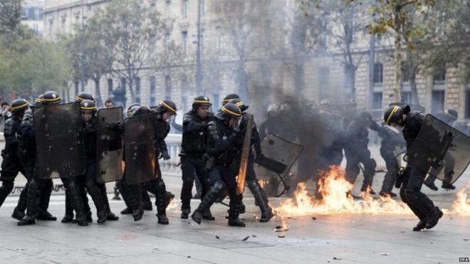 A petrol bomb explodes next to French riot police on the Place de la Republique, Paris, on 15 September 2016