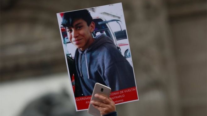 Демонстрант держит плакат с фотографией старшеклассника Марко Антонио Санчеса, пропавшего несколько дней назад после разногласий с полицейскими, как сообщают местные СМИ, во время марша протеста с требованием узнать его местонахождение у Ангела независимости в Мексике. Город, Мексика, 28 января 2018 года.