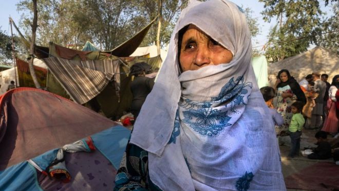 A woman cries as she talks about her son who was killed by the Taliban as displaced Afghans arrive at a makeshift camp in Kabul, Afghanistan.