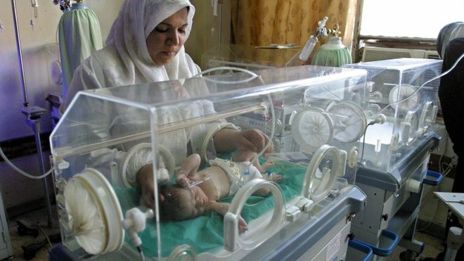 File photo showing an Iraqi nurse looks after a baby inside an incubator at Yarmouk hospital in Baghdad on 27 September 2004