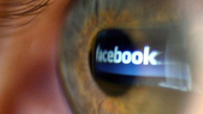 Facebook logo reflected in a person's eye. File photo