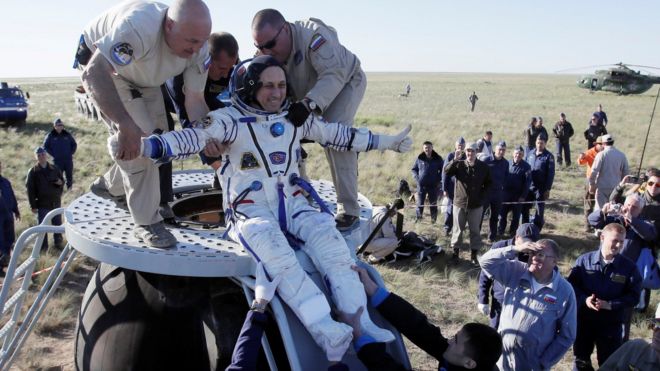 Ground crew help Anton Shkaplerov of Russia to get out of the Soyuz space capsule shortly after landing in Kazakhstan. 3 June 2018