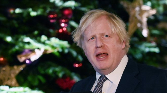 Boris Johnson in front of a Christmas tree