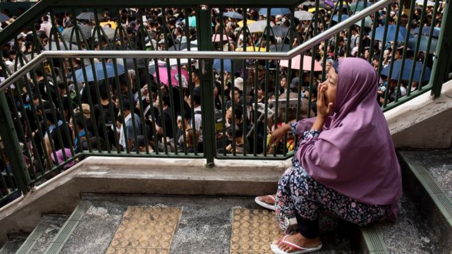 2019/07/21: An immigrant domestic helper rests during the day off as thousands of protesters take part in a mass rally
