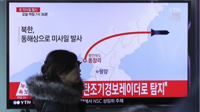 A visitor walks by the TV screen showing a news program reporting about North Korea"s missile firing, at Seoul Train Station in Seoul, South Korea, Monday, March 6, 2017