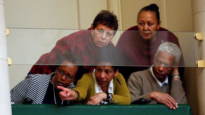 Audience members watch Mr Michel speak in parliament