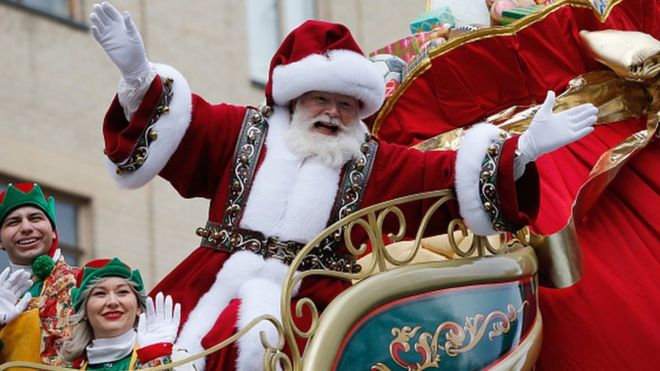 Santa Claus waves from his flotat during the annual Macy's Thanksgiving Day Parade in New York City, November 28, 2019