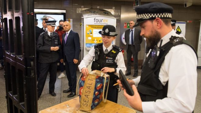Police searching a bag in Angel underground Station as Sajid Javid watches