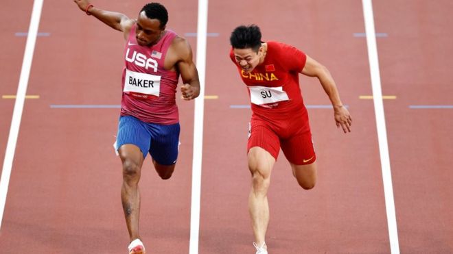 Ronnie Baker of United States and Su Bingtian of China compete in the Men's 100m final at the Tokyo Games