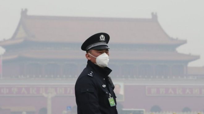 An officer wears a mask in Beijing