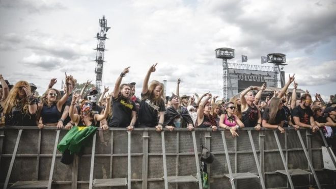 Fans celebrating the performance of the band Skindred during the Wacken Open Air festival on 4 August 2018 in Wacken, Germany