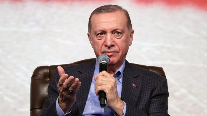President Recep Tayyip Erdogan holding a microphone