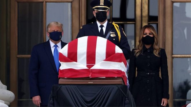 US President Donald Trump and Melania Trump behind Ruth Bader Ginsburg's casket