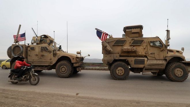 A US military vehicle tows another vehicle on the outskirts of the Syrian city of Qamishli on 12 February 2020