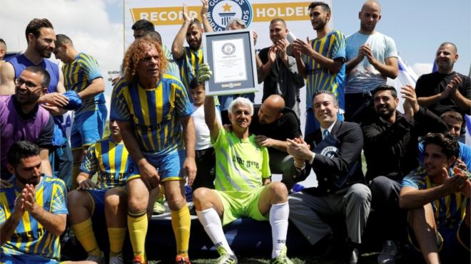 Isaak Hayik, the world's oldest football player, celebrating with his team after winning the Guinness World Record