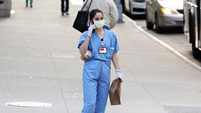 A medical worker wears a mask in New York