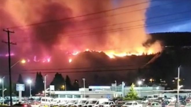 Flames rise as a wildfire burns on a hill in Kamloops, British Columbia, Canada July 1, 2021