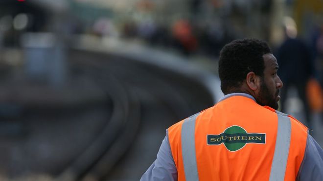 Проводник поезда во время работы на платформе на станции Восточный Кройдон