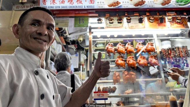 Singaporean chef Chan Hong Meng in front of his Michelin-starred chicken rice and noodle stall
