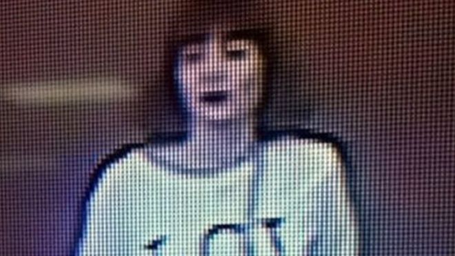 Grainy image shows a woman with brown hair wearing a T-shirt with the letters "LOL" emblazoned on it