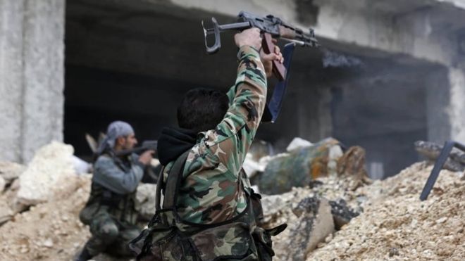 Syrian government soldiers fire their weapons in eastern Aleppo, Syria. Photo: 5 December 2016