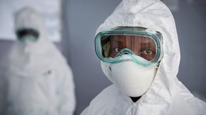 A medic wearing PPE looks at the camera during a simulation exercise at the Bwera General Hospital in 2018.
