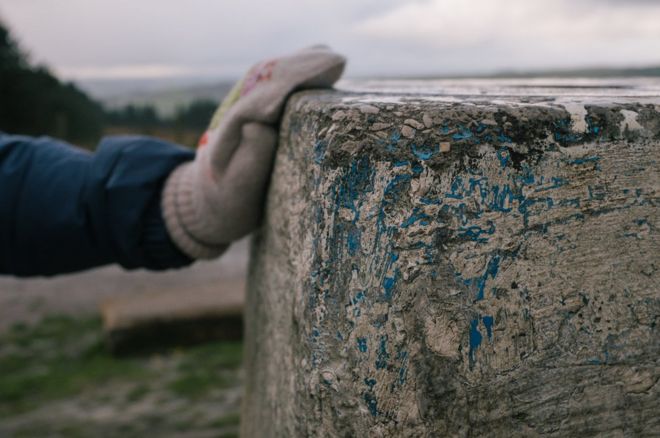 Hand on stone