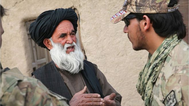 An Afghan interpreter with the U.S. Army's 4th squadron 2d Cavalry Regiment helps to question a villager