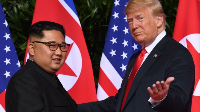 US President Donald Trump (R) meets with North Korea's leader Kim Jong Un (L) at the start of their US-North Korea summit, at the Capella Hotel on Sentosa Island in Singapore, 12 June 2018