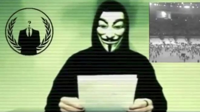 A man wearing a mask associated with Anonymous makes a statement in this still image from a video released on November 16, 2015