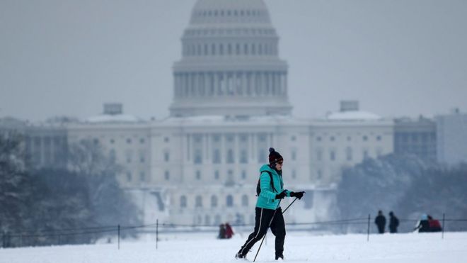 Лыжник по пересеченной местности проходит мимо Капитолия США во время зимнего шторма 13 января 2019 года в Вашингтоне