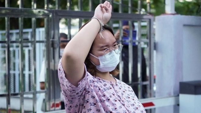 Protest leader Panusaya "Rung" Sithijirawattanakul, who has spent eight weeks in detention on charges of insulting the country"s king, shows a three-finger salut as she leaves after she was granted bail at the Central Women"s Correctional Institute in Bangkok, Thailand, May 6, 2021.