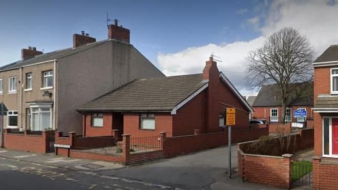 A google map image of the house which could be a funeral business with the school behind