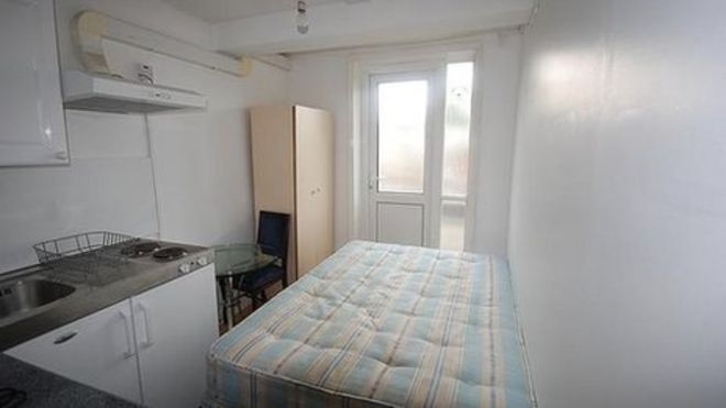 Tiny studio flat with bed and kitchen units