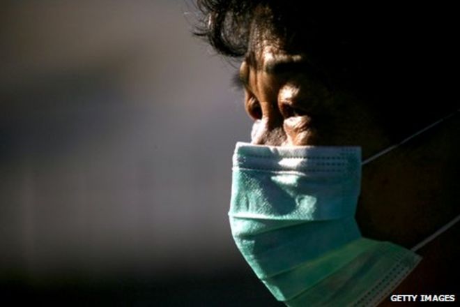 Мужчина в Гонконге в маске, чтобы защитить его от Сарса
