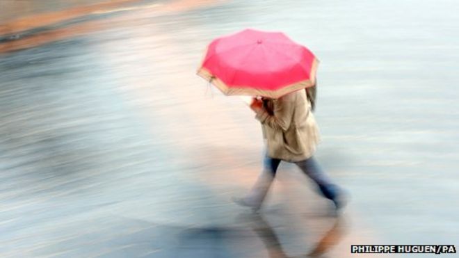 Женщина с зонтиком под дождем