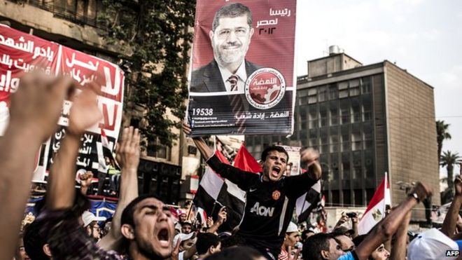 Сторонники Мухаммеда Мурси, кандидата Братьев-мусульман, протестуют против военных правителей Египта на площади Тахрир и празднуют преждевременную победу на президентских выборах в Каире, Египет, 23 июня 2012 года.