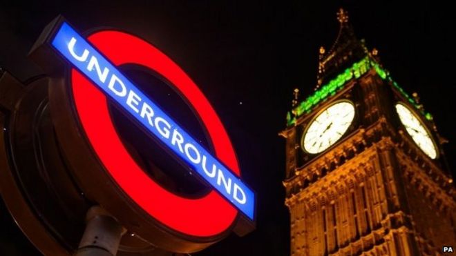 Знак лондонского метро перед зданием парламента
