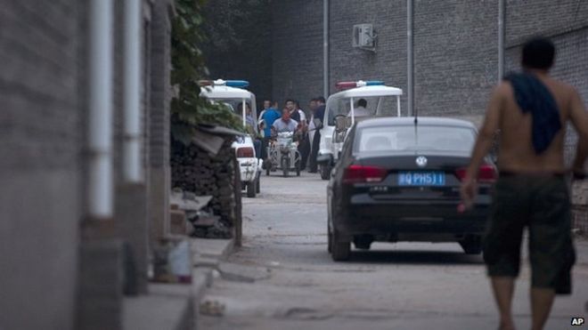 Китайские полицейские и мужчины, утверждающие, что являются сельскими жителями, блокируют переулок, ведущий к месту проведения Пекинского независимого кинофестиваля 23 августа 2014 года