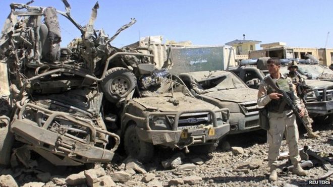 Сотрудники афганских сил безопасности следят за местом взрыва теракта-самоубийства в провинции Газни 4 сентября 2014 года.