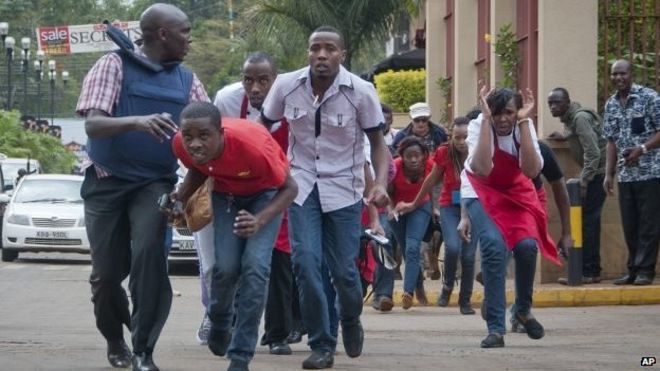 Гражданским лицам, которые прятались внутри во время перестрелок, удается бежать из торгового центра Westgate в Найроби, Кения. Суббота, 21 сентября 2013 г.