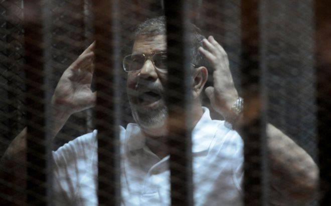 Свергнутый президент Египта Мухаммед Мурси в клетке обвиняемого на суде