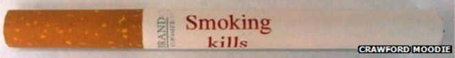 Сигарета с надписью «Курение убивает» красными чернилами