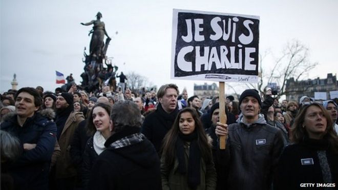 Люди с картонными надписями «Je suis Charlie» («Я - Чарли») принимают участие в митинге «Единство» на Площади нации в Париже 11 января 2015 года