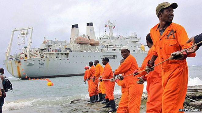 Workers haul part of a fibre optic cable onto the shore at the Kenyan port town of Mombasa in 2009, bringing internet connectivity from the United Arab Emirates