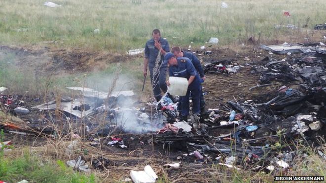 Water poured on remains of MH17 crash (July 2014)