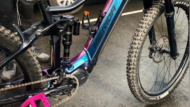 Image of a blue and pink mountain e-bike